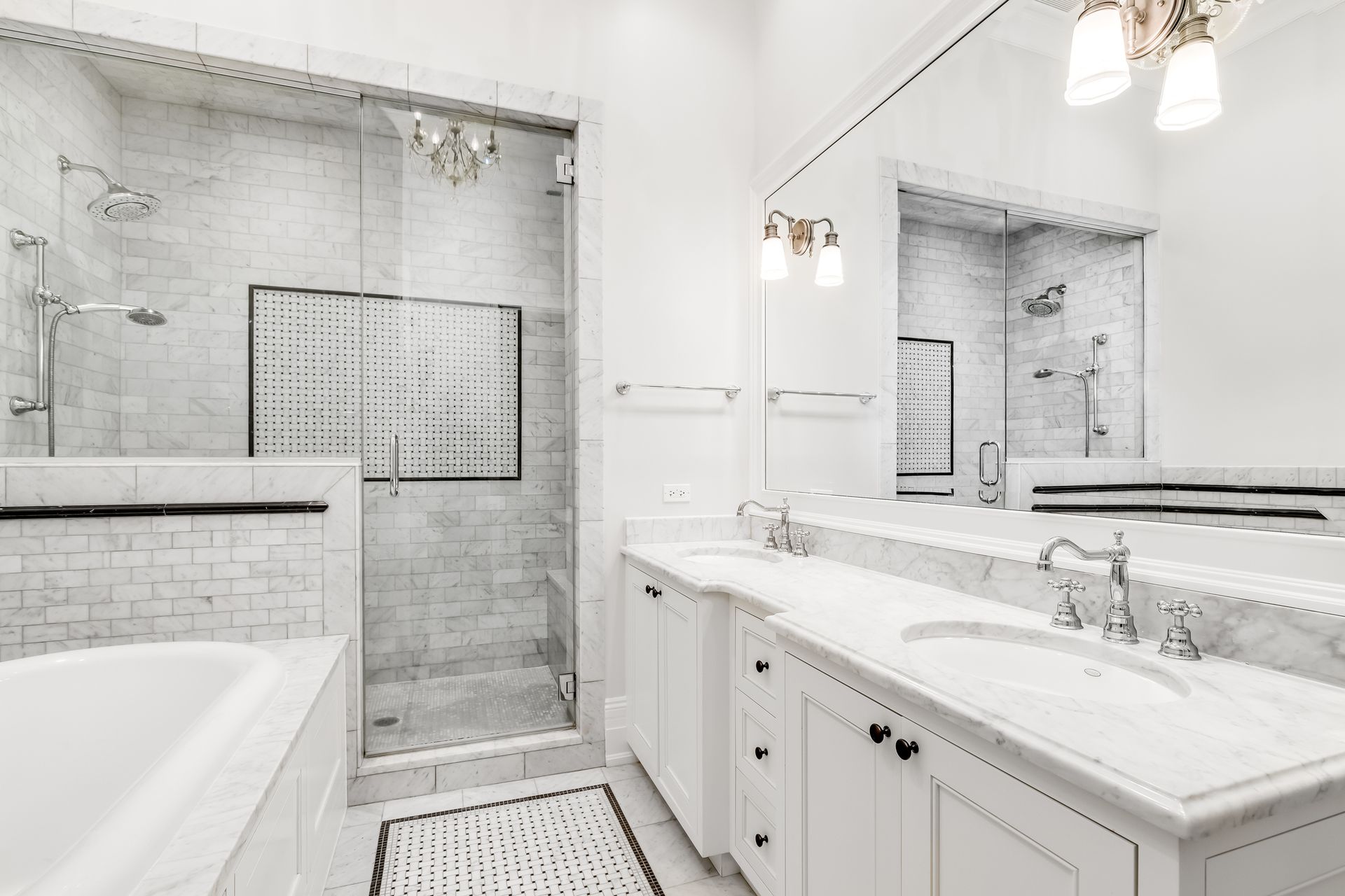 A finished master bathroom with a tiled walk-in shower and a double vanity