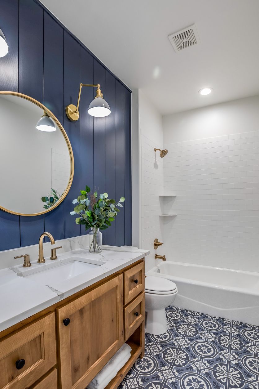 A large soaking tub set against a tiled bathroom wall