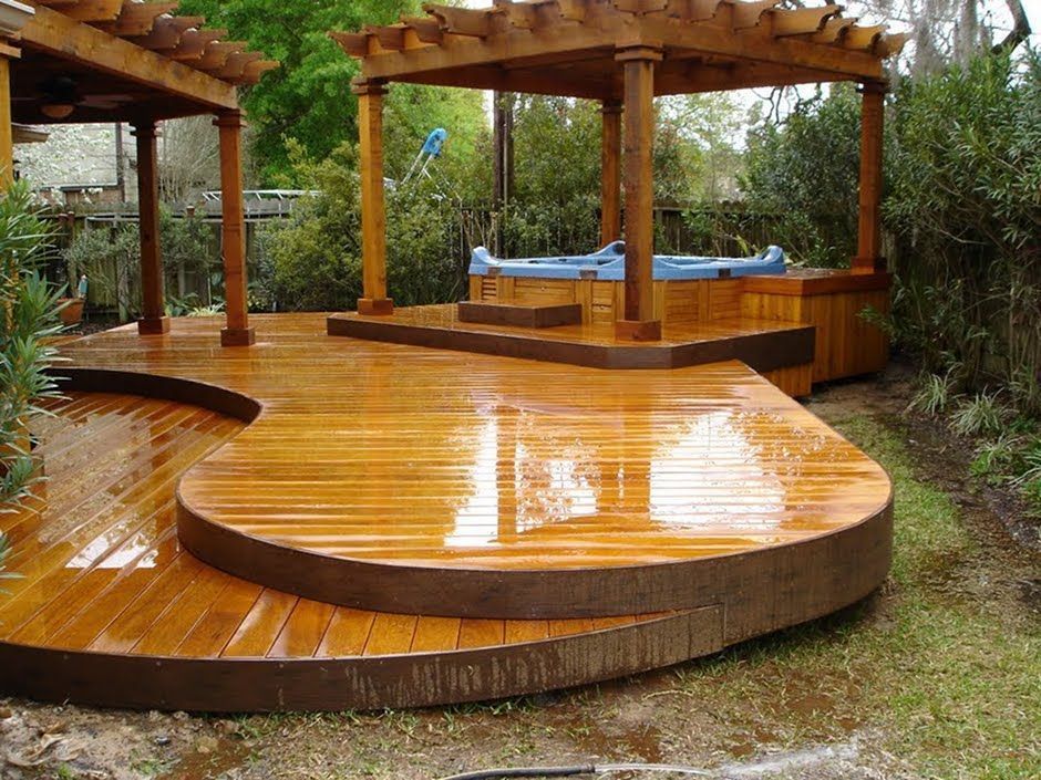 A custom timber deck with built-in seating overlooking a back garden