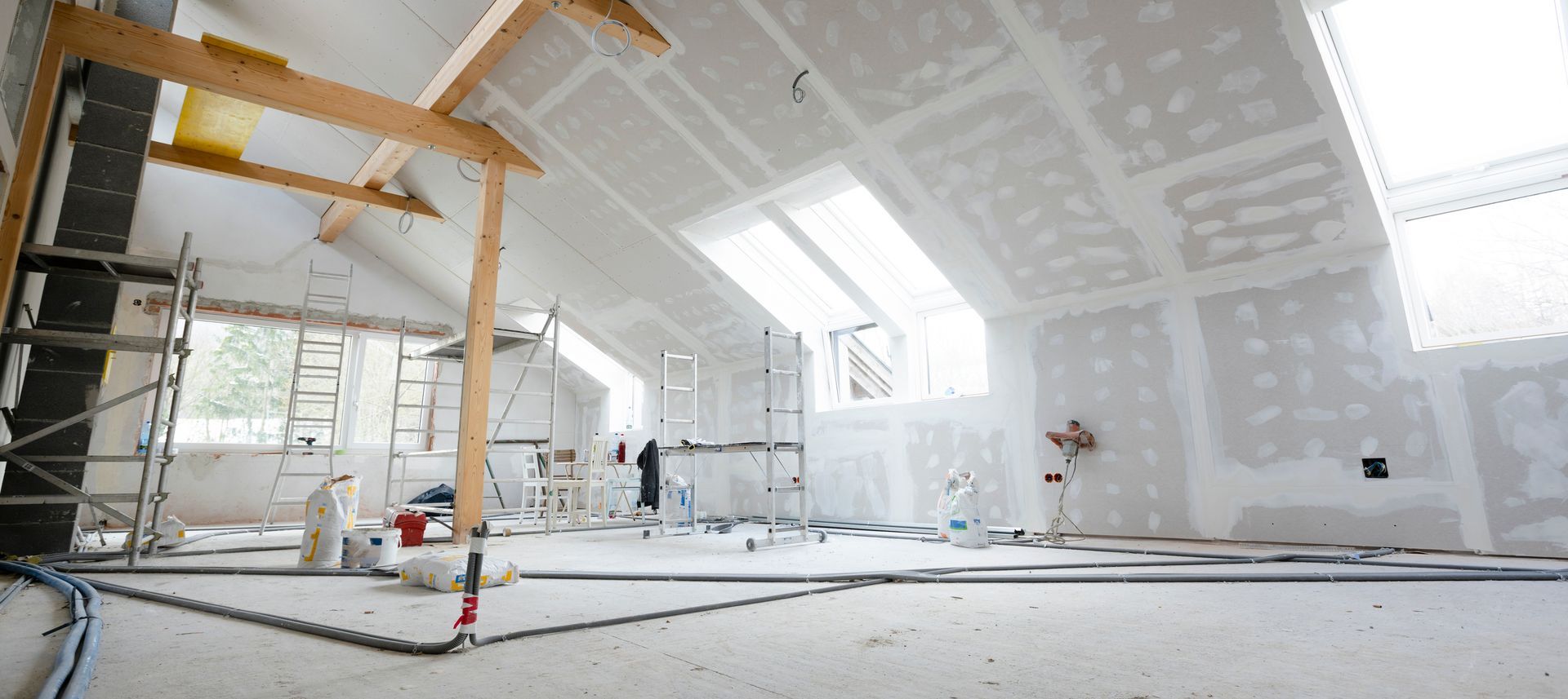 A freshly drywalled and painted room with smooth white walls and ceiling