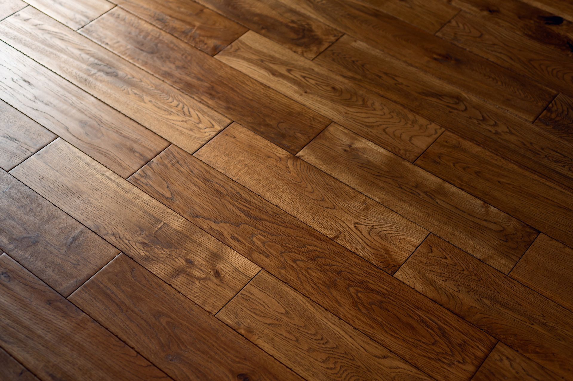Wide plank hardwood flooring newly laid through an open living space