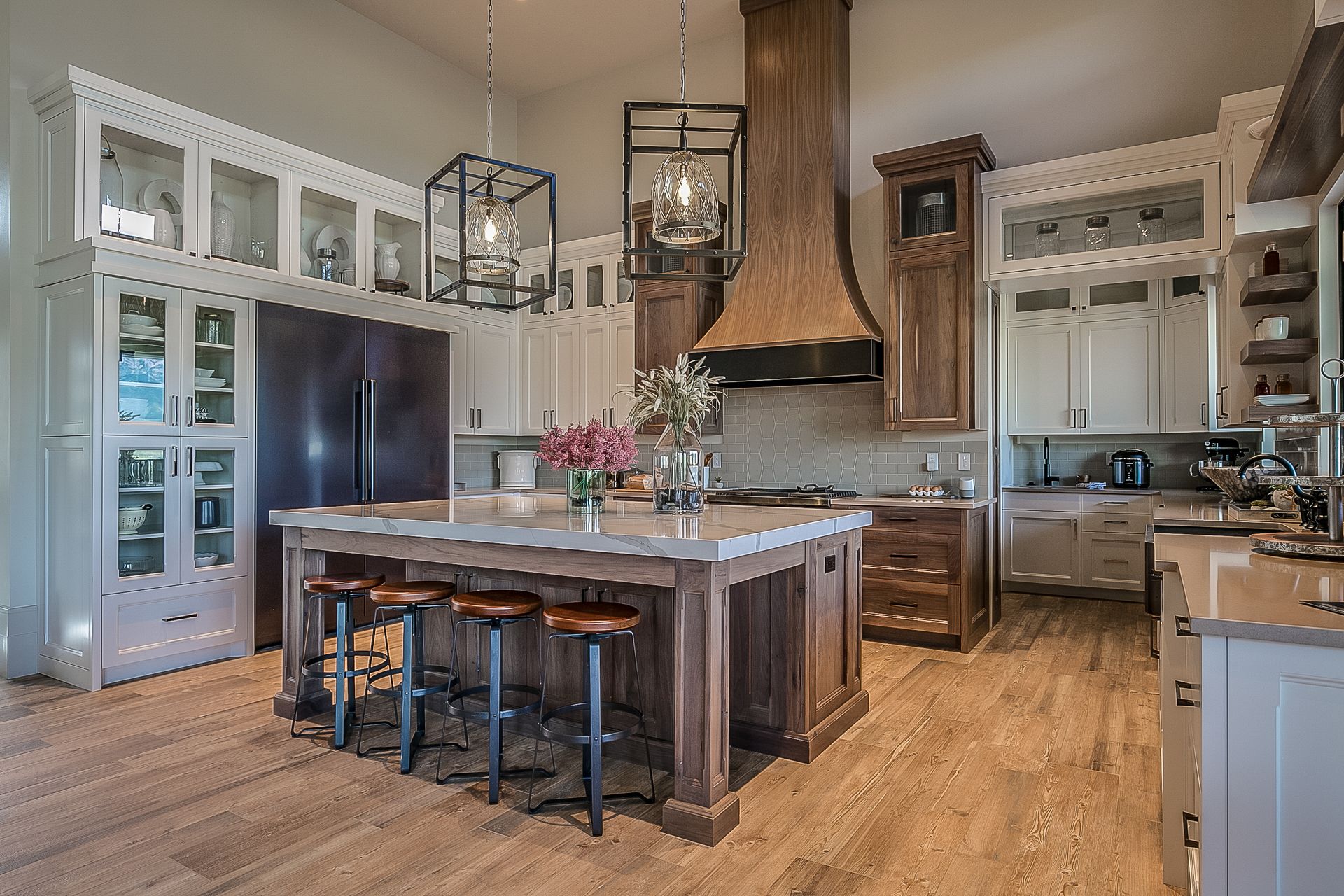 A remodelled kitchen with a large island, custom cabinetry and a timber range hood