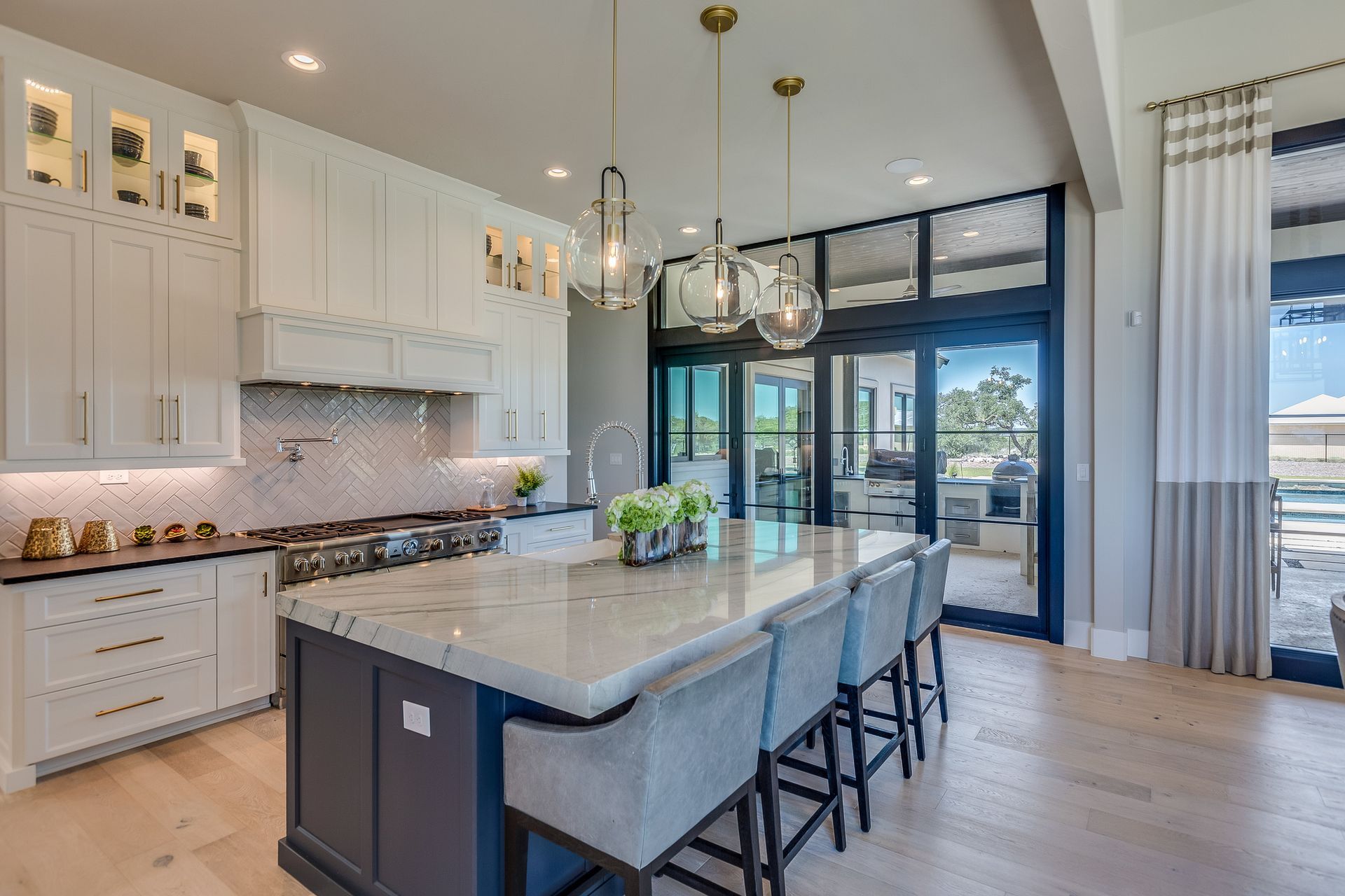 A finished kitchen island with pendant lighting and bar seating