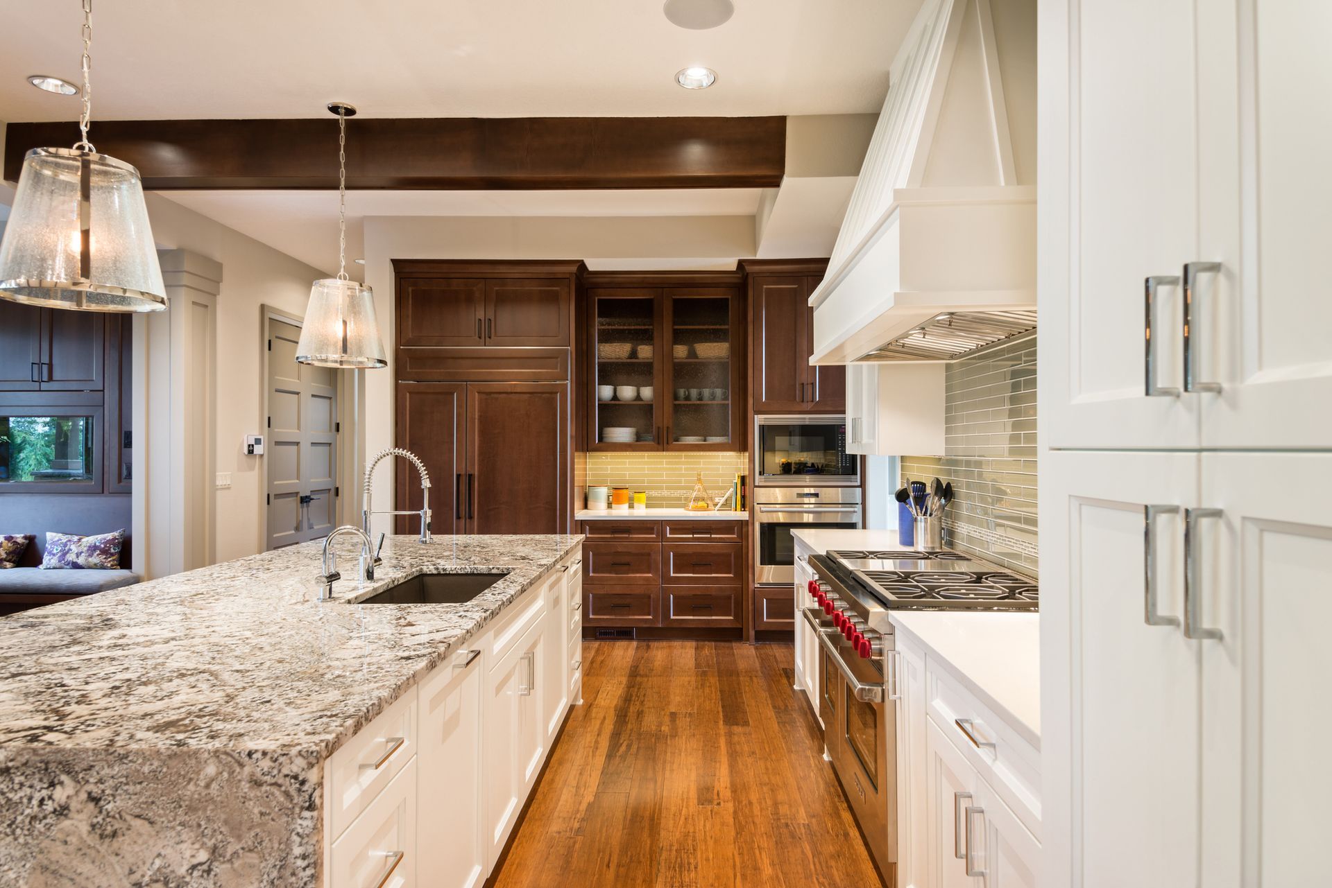 A remodelled kitchen with custom cabinetry and stone countertops