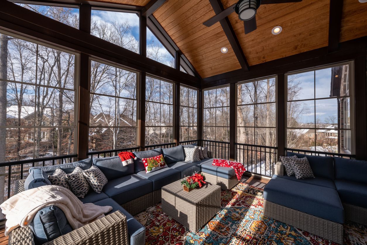 A bright sunroom with a timber ceiling and full-height windows onto the garden