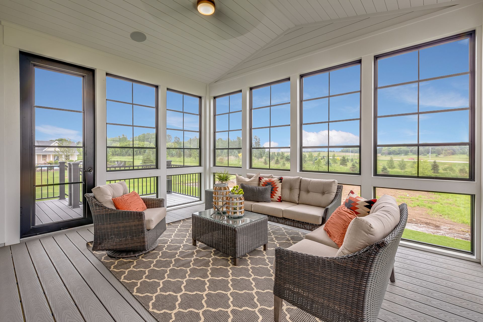 A sunroom addition with full-height windows and a vaulted ceiling